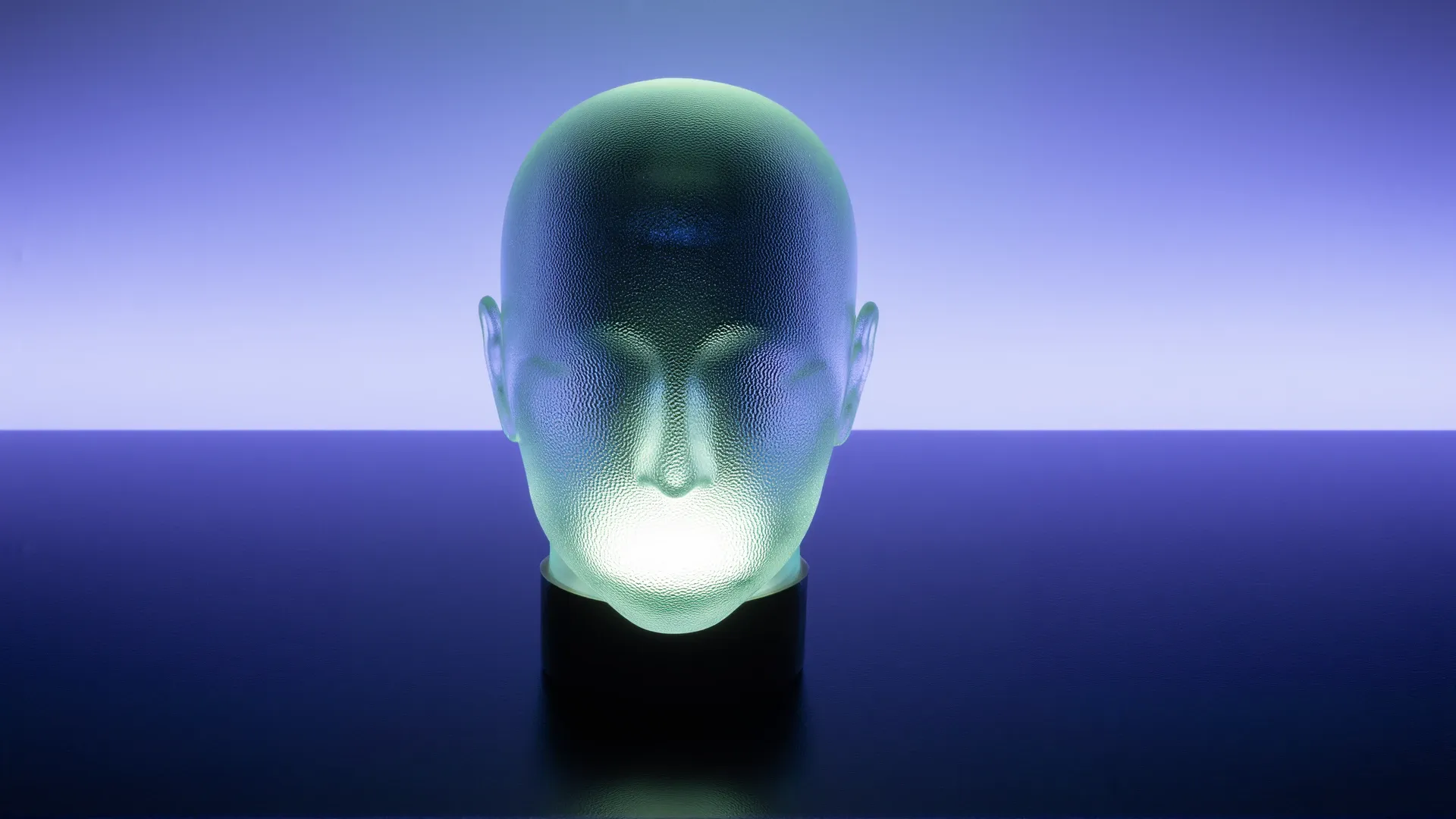 A translucent frosted-glass human head glowing softly from within against a deep blue void — visibly lit inside, yet impossible to see into.